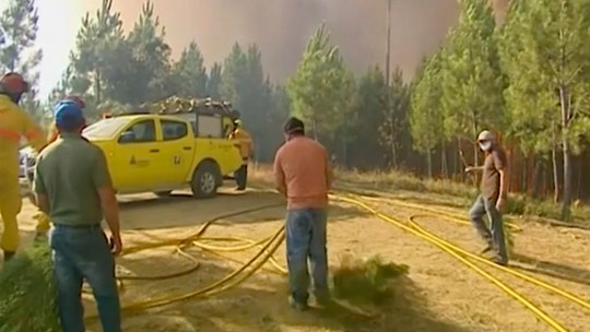 Hundreds of firefighters tackle wildfires in Portugal, village evacuated