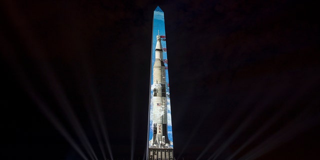 The image of a 363-foot Saturn V rocket is projected on the east face of the Washington Monument in Washington, Wednesday, July 17, 2019, in celebration of the 50th anniversary of the Apollo 11 moon landing. (AP)