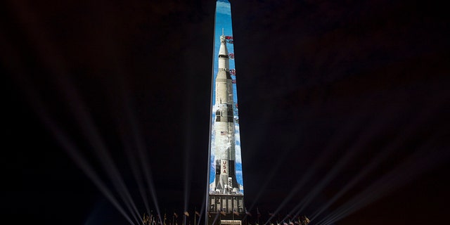 The image of a 363-foot Saturn V rocket is projected on the east face of the Washington Monument in Washington, Wednesday, July 17, 2019, in celebration of the 50th anniversary of the Apollo 11 moon landing. (AP)