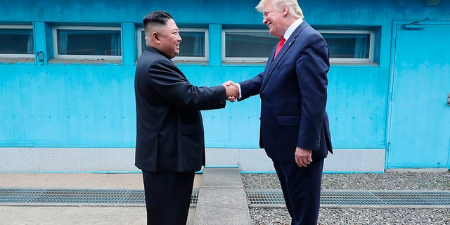Kim Jong Un and President Trump shake hands over the military demarcation line at the border village of Panmunjom in the Demilitarized Zone in 2019. (Korean Central News Agency/Korea News Service/ AP)