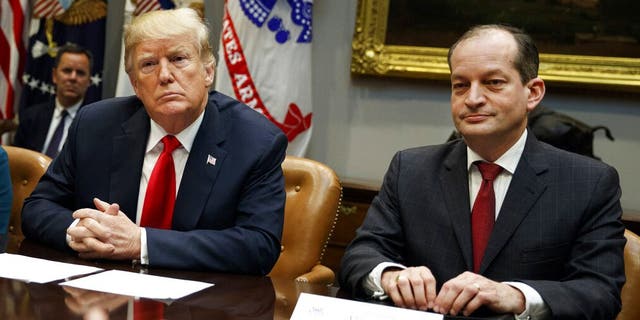 In this Sept. 17, 2018, photo, President Trump and Labor Secretary Alexander Acosta listen during a meeting of the President's National Council of the American Worker in Washington. (AP Photo/Evan Vucci, File)