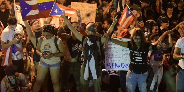 Demonstrators protest against governor Ricardo Rossello, in San Juan, Puerto Rico, Friday, July 19, 2019. Protesters are demanding Rossello step down for his involvement in a private chat in which he used profanities to describe an ex-New York City councilwoman and a federal control board overseeing the island's finance.
