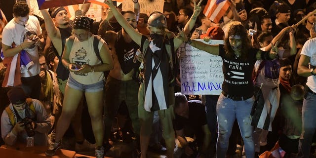 Demonstrators protest against governor Ricardo Rossello, in San Juan, Puerto Rico, Friday, July 19, 2019. Protesters are demanding Rossello step down for his involvement in a private chat in which he used profanities to describe an ex-New York City councilwoman and a federal control board overseeing the island's finance.