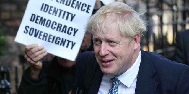 Conservative party leadership contender Boris Johnson, is shadowed by a Brexit demonstrator, as he arrives at his office in central London, Tuesday July 23, 2019. Britain’s governing Conservative Party is set to reveal the name of the country’s next prime minister later Tuesday, with Brexit champion Boris Johnson widely considered to be favourite to get the job against fellow contender Jeremy Hunt.