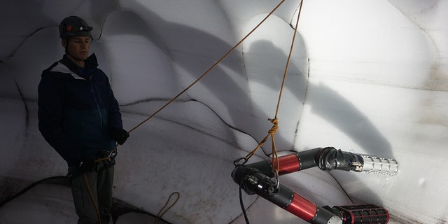 Ice Worm climbs on an icy wall in the manner of a white worm, an adaptation of LEMUR's design. (Credit: NASA / JPL-Caltech)