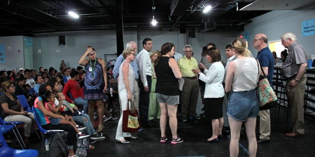 Abby Johnson (in shorts and black top) speaking with Democratic members of Congress at the respite center in McAllen, Texas. 
