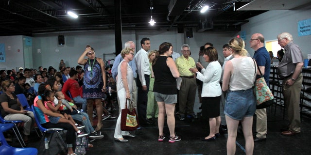 Abby Johnson (in shorts and black top) speaking with Democratic members of Congress at the respite center in McAllen, Texas.