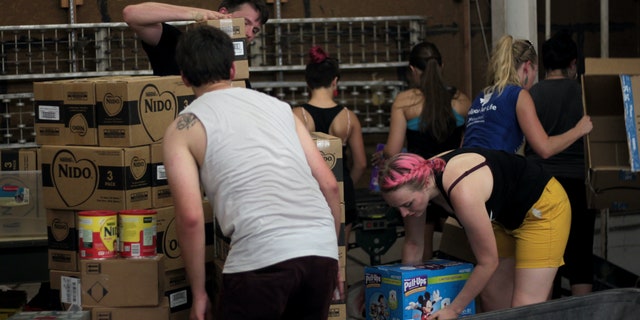 Volunteers unloading supplies into respite center in McAllen, Texas.