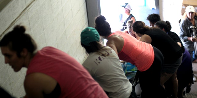Volunteers line up to get supplies from the truck into the respite center warehouse in McAllen, Texas.