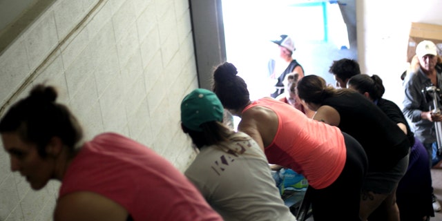 Volunteers line up to get supplies from the truck into the respite center warehouse in McAllen, Texas.