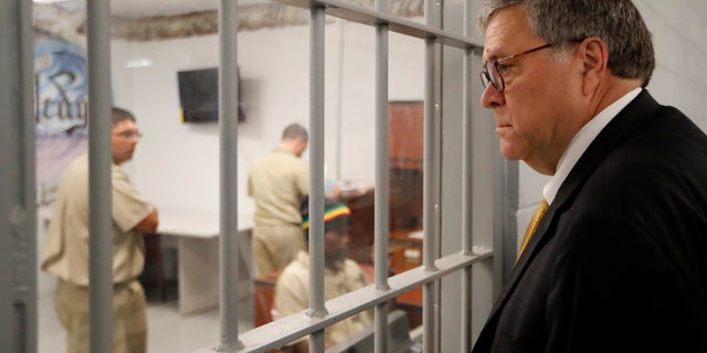 Attorney General William Barr watches as inmates work in a computer class during a tour of a federal prison Monday, July 8, 2019, in Edgefield, S.C. (AP Photo/John Bazemore)