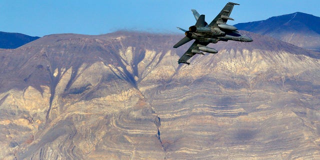 FILE - In this Feb. 27, 2017 file photo, an F/A-18D Hornet from the VX-9 Vampire squadron at Naval Air Weapons Station China Lake, flies out of what is known as Star Wars Canyon toward the Panamint range in Death Valley National Park, Calif. On Wednesday, July 31, 2019 a U.S. Navy F/A-18 Super Hornet jet crashed Wednesday in the California desert and a search-and-rescue operation was underway, officials said. The single-seat warplane went down at 9:50 a.m. during a routine training mission north of the China Lake base. (AP Photo/Ben Margot, File)