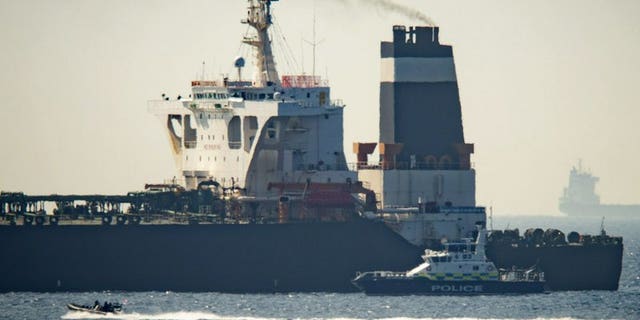 Royal Marine patrol vessel is seen beside the Grace 1 super tanker in the British territory of Gibraltar, Thursday, July 4, 2019. Authorities in Gibraltar said they intercepted Thursday an Iranian supertanker believed to be breaching European Union sanctions by carrying a shipment of Tehran's crude oil to war-ravaged Syria.