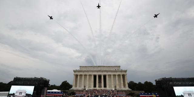 President Donald Trump, first lady Melania Trump, Vice President Mike Pence and Karen Pence and others stand as the US Army Band performs and the US Navy Blue Angels flyover at the end of an Independence Day celebration in front of the Lincoln Memorial, Thursday, July 4, 2019, in Washington.