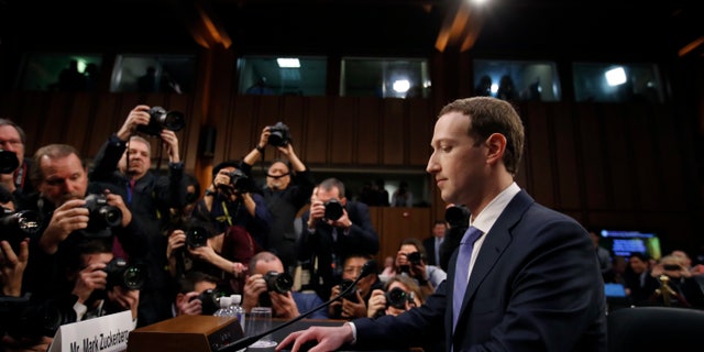 FILE - In this April 10, 2018, file photo Facebook CEO Mark Zuckerberg takes his seat to testify before a joint hearing of the Commerce and Judiciary Committees on Capitol Hill in Washington. The Washington Post reported on Tuesday, July 23, 2019, that the Federal Trade Commission will allege that Facebook misled users about its privacy practices as part of an expected settlement.(AP Photo/Alex Brandon, File)