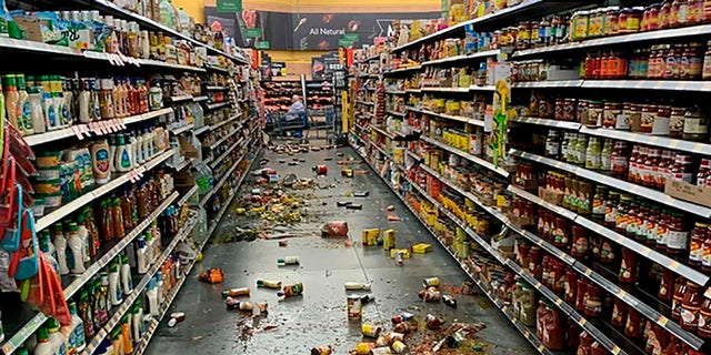 Food that fell from the shelves litters the floor of an aisle at a Walmart following an earthquake in Yucca Yalley, Calif., on Friday, July 5, 2019. (Chad Mayes via AP)