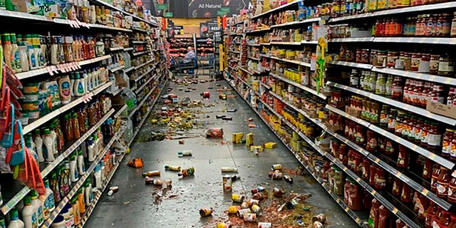 Food that fell from the shelves litters the floor of an aisle at a Walmart following an earthquake in Yucca Valley, Calif., on Friday, July 5, 2019. (Associated Press)