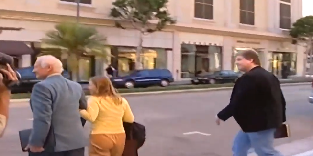 Screenshot from YouTube video showing Buzz Aldrin attempting to avoid an encounter with a moon-landing conspiracy theorist.