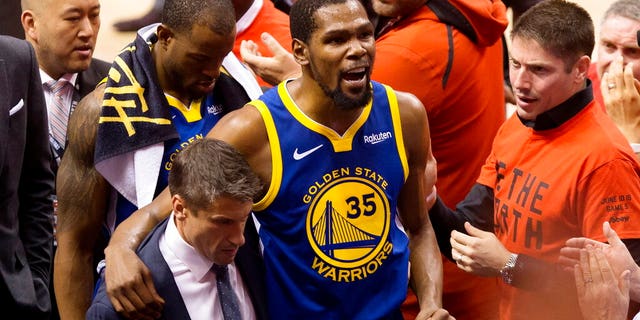 FILE: Golden State Warriors forward Kevin Durant (35) reacts as he leaves the court after sustaining an injury during first-half basketball action against the Toronto Raptors in Game 5 of the NBA Finals in Toronto.