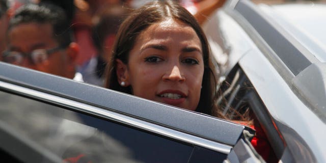 FILE: Rep. Alexandria Ocasio-Cortez, of New York, gets in an SUV after touring the inside of the Border Patrol station in Clint, Texas.