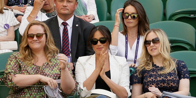 Meghan, Duchess of Sussex, center, applauds from her seat on Court Number One during day four of the Wimbledon Tennis Championships. (AP Photo/Tim Ireland)