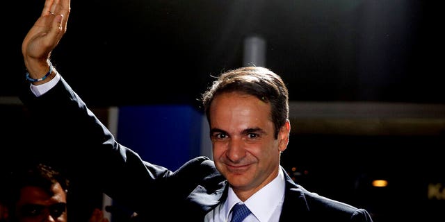 Greek opposition New Democracy conservative party leader Kyriakos Mitsotakis waves to his supporters after win in parliamentary elections at the New Democracy headquarters in Athens, on Sunday, July 7, 2019.Â 