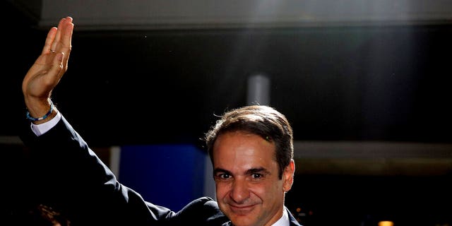 Greek opposition New Democracy conservative party leader Kyriakos Mitsotakis waves to his supporters after win in parliamentary elections at the New Democracy headquarters in Athens, on Sunday, July 7, 2019.