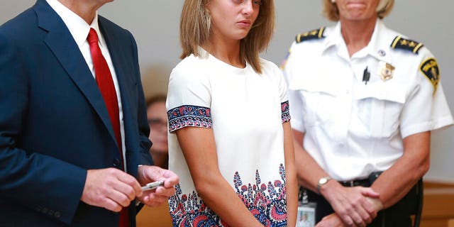 FILE: Michelle Carter, center, listens to her involuntary rape judgment to encourage 18-year-old Conrad Roy III to kill in July 2014.