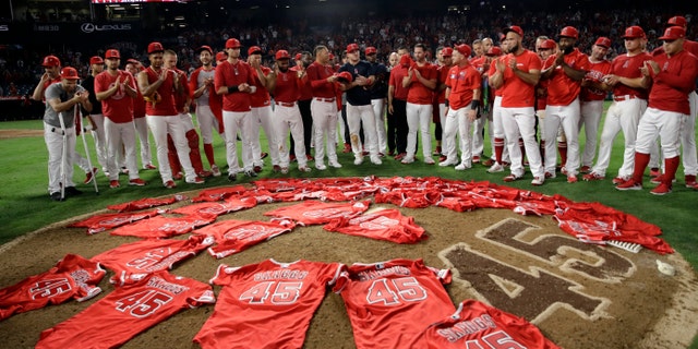 Members of the Los Angeles Angels place their jerseys with No. 45 in honor of pitcher Tyler Skaggs on the mound after a combined no-hitter against the Seattle Mariners in the first game after Skagg's death.