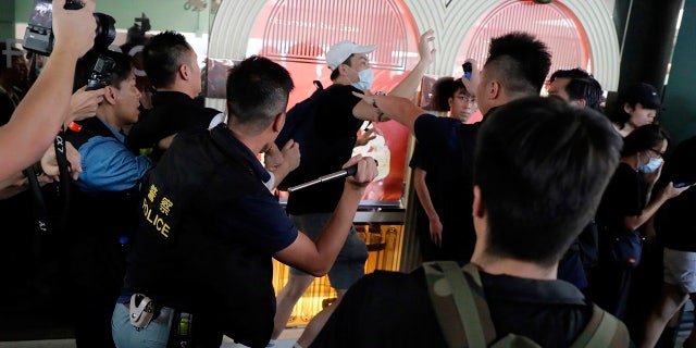 Police attack a protester in Hong Kong Saturday, July 13, 2019. Several thousand people marched in Hong Kong on Saturday against traders from mainland China in what is fast becoming a summer of unrest in the semi-autonomous Chinese territory. (AP Photo/Kin Cheung)