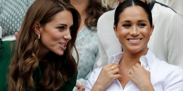 Kate, the Duchess of Cambridge, left, and Meghan, the Duchess of Sussex, argue while they watch Serena Williams play Simona Halep. 