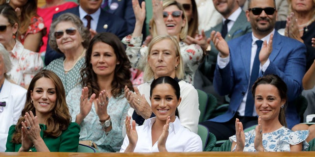 Kate, Duchess of Cambridge; Meghan, Duchess of Sussex; and Pippa Matthews, from left to right, sit in the Royal Box on the central court. 