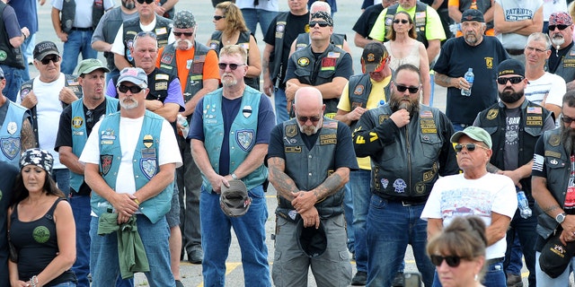 Participants observe a moment of silence during Saturday's memorial service.