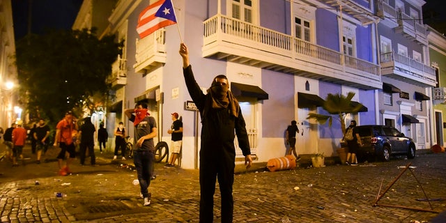 A tenement requiring the resignation of Governor Ricardo Rosselo on Monday. (AP Photo / Carlos Giusti)