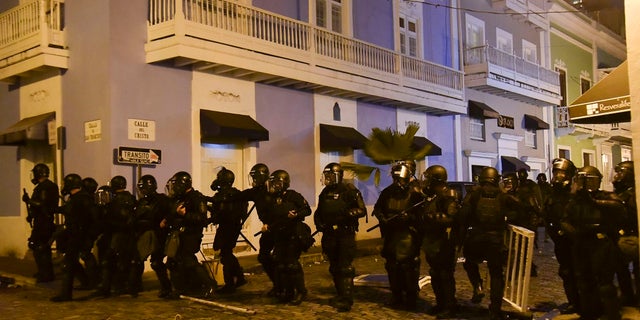 Police parts protect the area near the executive house from protesters seeking the resignation of the Governor of Puerto Rico. (AP Photo / Carlos Giusti)