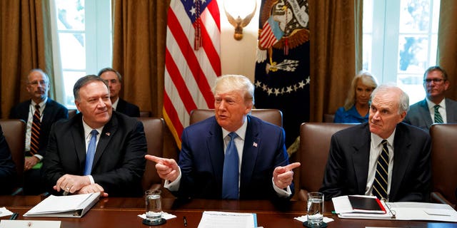 In this image, then-President Donald Trump speaks during a Cabinet meeting in the Cabinet Room of the White House, on July 16, 2019, in Washington, D.C. Trump is accompanied by Secretary of State Mike Pompeo, at left, and acting Defense Secretary Richard Spencer.