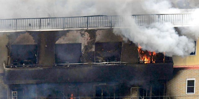 Smoke billows from a Kyoto Animation building in Kyoto, western Japan, Thursday, July 18, 2019. The fire broke out in the three-story building in Japan's ancient capital of Kyoto, after a suspect sprayed an unidentified liquid to accelerate the blaze, Kyoto prefectural police and fire department officials said.