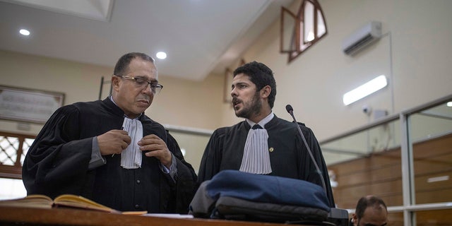 Lawyers gather inside a courtroom before the start of a final trial session for suspects charged in connection with the killing of two Scandinavian tourists in Morocco, in Sale, near Rabat, Morocco, Thursday, July 18, 2019.