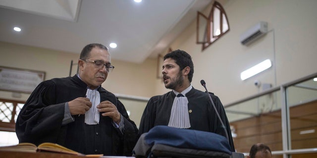 Lawyers gather inside a courtroom before the start of a final trial session for suspects charged in connection with the killing of two Scandinavian tourists in Morocco, in Sale, near Rabat, Morocco, Thursday, July 18, 2019.