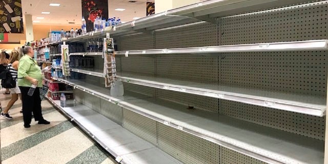Shoppers look at empty shelfs as a high demand for large jugs of water are sold out at the Coral Ridge Mall Publix after a water main break Thursday, July 18, 2019 in Fort Lauderdale, Fla. (Linda Trischitta/South Florida Sun-Sentinel via AP)