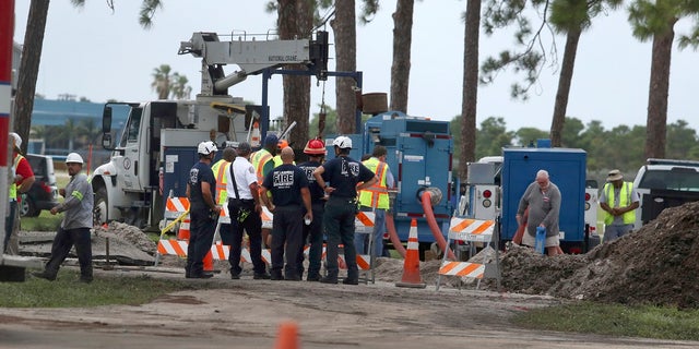 Fort Lauderdale fire rescue work the scene of a water main break near the Fort Lauderdale Executive Airport Thursday, July 18, 2019. (Carline Jean/South Florida Sun-Sentinel via AP)