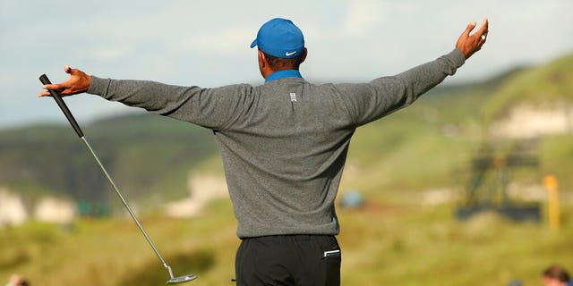 Tiger Woods of the United States celebrates after getting a birdie on the 16th green during the first round of the British Open Golf Championships at Royal Portrush in Northern Ireland, Thursday, July 18, 2019.(AP Photo/Jon Super)