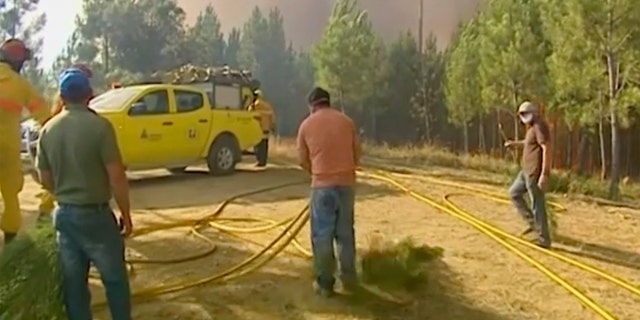 Massive wildfire in Portugal under control, firefighters remain on ground
