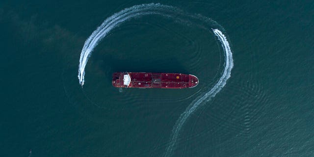 FILE: An aerial view shows a speedboat of Iran's Revolutionary Guard moving around the British-flagged oil tanker Stena Impero which was seized in the Strait of Hormuz on Friday by the Guard, in the Iranian port of Bandar Abbas.