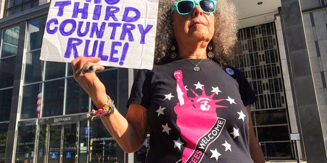 Arla Ertz holding a protest sign outside of the San Francisco Federal Courthouse on Wednesday.