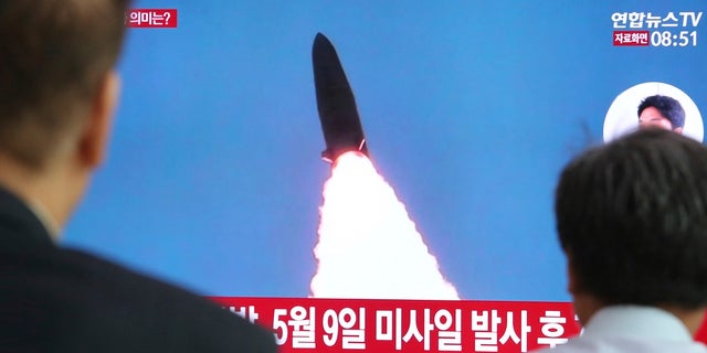 People watch a TV that shows a file image of a North Korean missile launch during a news program at Seoul Railway Station, South Korea.