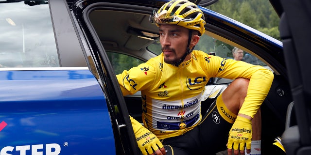 France's Julian Alaphilippe wearing the overall leader's yellow jersey sits in the team director car during the nineteenth stage of the Tour de France cycling race over 126,5 kilometers (78,60 miles) with start in Saint Jean De Maurienne and finish in Tignes, France, Friday, July 26, 2019. Tour de France organizers stopped Stage 19 of the race because of a hail storm as Julien Alaphilippe lost his yellow jersey to Egan Bernal. (AP Photo/Thibault Camus)