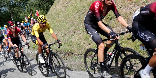 Colombia's Egan Bernal wearing the overall leader's yellow jersey climbs toward Val Thorens with Britain's Geraint Thomas, left, and Netherland's Dylan Van Baarle during the twentieth stage of the Tour de France cycling race.