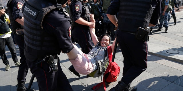Russian police are wrestling with demonstrators and have arrested hundreds in central Moscow during a protest demanding that opposition candidates be allowed to run for the Moscow city council. (AP Photo/Alexander Zemlianichenko)