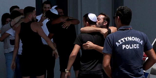 An Israeli teenager embraced by relatives after being released from Famagusta police headquarters in Paralimni, Cyprus, on Sunday. (AP Photo/Petros Karadjias)